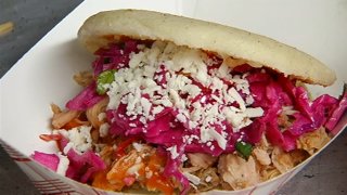 A sandwich loaded with chicken, cheese and vegetables is seen at Chicago Food Truck Festival