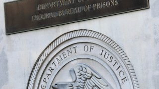 a sign for the Department of Justice Federal Bureau of Prisons is displayed at the Metropolitan Detention Center in the Brooklyn borough of New York