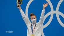 Lydia Jacoby, of the United States, poses with the gold medal after winning the final of the women's 100-meter breaststroke at the 2020 Olympics on July 27, 2021, in Tokyo, Japan.