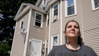 Roxanne Schaefer, of West Warwick, R.I., stands for a photograph outside of her apartment building