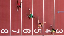 Shelly-Ann Fraser-Pryce of Jamaica, Ajla Del Ponte of Switzerland, Nzubechi Nwokocha of Nigeria and Gina Bass of Gambia compete during the first round of the women's 100-meter the 2020 Summer Olympics, Friday, July 30, 2021, in Tokyo.