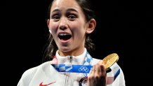 Gold medallist USA's Lee Kiefer celebrate on podium during the medal ceremony for the women's foil individual during the Tokyo 2020 Olympic Games at the Makuhari Messe Hall in Chiba City, Chiba Prefecture, Japan, on July 25, 2021.