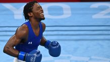Keyshawn Davis celebrates after winning against France's Sofiane Oumiha after their men's light (57-63kg) preliminaries round at the Tokyo 2020 Olympic Games at the Kokugikan Arena in Tokyo on July 31, 2021.