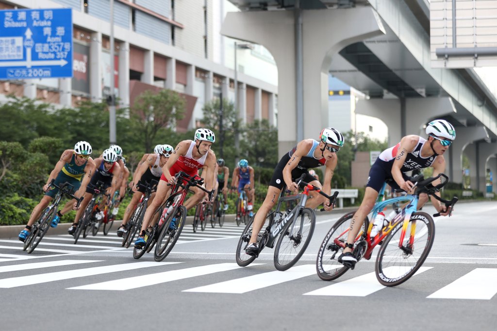 Alex Yee of Team Great Britain rides ahead of Stefan Zachaus of Team Luxembourg, Matthew Sharpe of Team Canada and other competitors during the Men's Individual Triathlon on day three of the Tokyo 2020 Olympic Games at Odaiba Marine Park on July 26, 2021 in Tokyo, Japan.