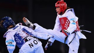 BAKU, AZERBAIJAN - JUNE 19: Tina Skaar of Norway (blue) and Reshmie Oogink of the Netherlands (red) compete in the Women's +67kg Taekwondo Preliminary Round during day seven of the Baku 2015 European Games at the Crystal Hall on June 19, 2015 in Baku, Azerbaijan.