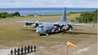 This April 21, 2017, file photo shows a Philippine Air Force C-130 transport plane as Philippine troops march at the Philippine-claimed Thitu Island off the disputed Spratlys chain of islands in the South China Sea in western Philippines. The Philippine military chief said Sunday, July 4, 2021, a C-130 plane carrying troops has crashed in the country’s south after missing the runway and multiple people have been rescued.