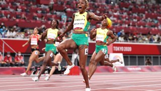 OKYO, JAPAN - JULY 31: Elaine Thompson-Herah of Team Jamaica celebrates after winning the gold medal in the Women's 100m Final on day eight of the Tokyo 2020 Olympic Games at Olympic Stadium on July 31, 2021 in Tokyo, Japan. (Photo by Michael Steele/Getty Images)