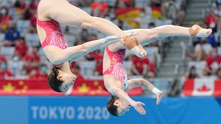 Wang Han and Shi Tingmao perform a dive as part of their gold medal winning sychro springboard list.