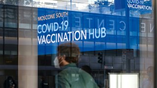 People stand in line at the mass vaccination site at San Francisco’s Moscone Convention Center that opened today for healthcare workers and people over 65 on February 5, 2021 in San Francisco, California.