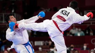 Sajad Ganjzadeh of Iran, left, is injured while competing against Tareg Hamedi