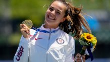 Nevin Harrison, of the United States, holds her up gold medal