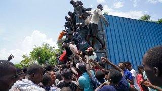 Residents overtake a truck loaded with relief supplies in Vye Terre, Haiti, Friday, Aug. 20, 2021. Private aid and shipments from the U.S. government and others were arriving in the country's southwestern peninsula that was struck by a 7.2 magnitude quake on Aug. 14.