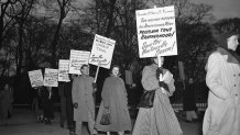 Demonstrators march in front of the White House in Washington, Jan. 30, 1951, in what they said was an effort to persuade President Harry Truman to halt the execution of seven Black men sentenced to death in Virginia on charges of raping a white woman. Virginia Gov. Ralph Northam granted posthumous pardons Tuesday, Aug. 31, 2021 to seven Black men who were executed in 1951.
