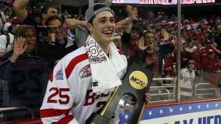 WASHINGTON – APRIL 11: Colby Cohen #25 of the Boston Terriers celebrates with the championship trophy after defeating the Miami Red Hawks during the NCAA Men’s Frozen Four Championship game on April 11, 2009 at the Verizon Center in Washington, DC. Boston defeated Miami 4-3 in overtime to win the national title. (Photo by Elsa/Getty Images)