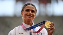 Gold medallist USA's Sydney Mclaughlin poses with her medal on the podium after the women's 400m hurdles event during the Tokyo 2020 Olympic Games at the Olympic Stadium in Tokyo, Japan on Aug. 4, 2021.