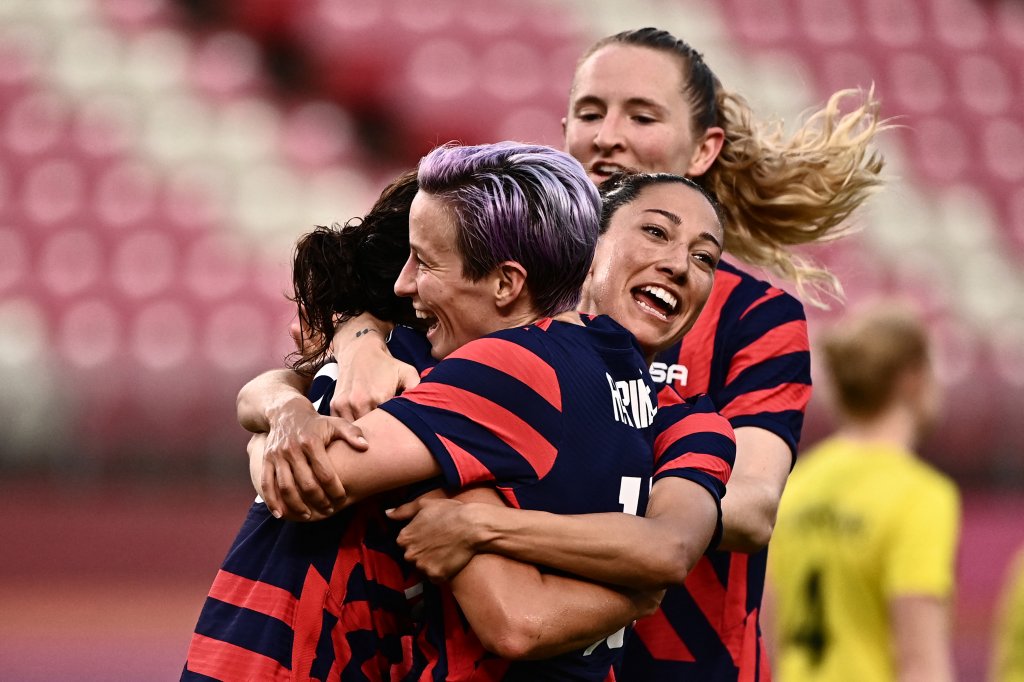 USA's forward Carli Lloyd, left, is congratulated by teammates after scoring during the Tokyo 2020 Olympic Games women's bronze medal football match between Australia and the United States at Ibaraki Kashima Stadium in Kashima city, Ibaraki prefecture on Aug. 5, 2021.