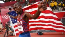 Team USA's Paul Chelimo celebrates with the national flag after winning the bronze medal in the men's 5000m final during the Tokyo 2020 Olympic Games at the Olympic Stadium in Tokyo on Aug. 6, 2021.
