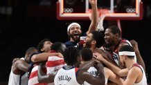 USA's players celebrate their victory at the end of the men's final basketball match between France and USA during the Tokyo 2020 Olympic Games at the Saitama Super Arena in Saitama, Japan on Aug. 7, 2021.