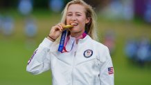 Gold medallist Nelly Korda of Team USA bites her medal on the podium during the victory ceremony of the women's golf individual stroke play during the Tokyo 2020 Olympic Games at the Kasumigaseki Country Club in Kawagoe on Aug. 7, 2021.