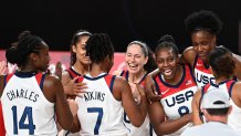 USA's players celebrate their victory at the end of the women's final basketball match between USA and Japan during the Tokyo 2020 Olympic Games at the Saitama Super Arena in Saitama on August 8, 2021.