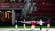 The Olympic flag is carried during the closing ceremony of the Tokyo 2020 Olympic Games, at the Olympic Stadium, in Tokyo, on Aug. 8, 2021.