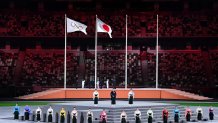 Performers sing the Japanese national anthem as the Olympic flag and Japan's flag are raised during the closing ceremony of the Tokyo 2020 Olympic Games, at the Olympic Stadium, in Tokyo, on Aug. 8, 2021.