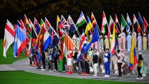 Athletes carry their nations' flags to the field of play during the closing ceremony of the Tokyo 2020 Olympic Games, on Aug. 8, 2021 at the Olympic Stadium in Tokyo.