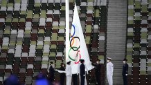 The Olympic flag is taken down during the closing ceremony of the Tokyo 2020 Olympic Games, at the Olympic Stadium, in Tokyo, on Aug. 8, 2021.