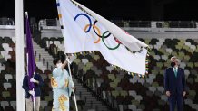 Tokyo's governor Yuriko Koike waves the Olympic flag during the closing ceremony of the Tokyo 2020 Olympic Games, at the Olympic Stadium, in Tokyo, on Aug. 8, 2021.