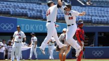 Triston Casas #26 and Tyler Austin #23 of Team United States celebrate Casas' two-run home run as catcher Charlie Valerio #7 Team Dominican Republic looks on in the first inning during the knockout stage of men's baseball on day twelve of the Tokyo 2020 Olympic Games at Yokohama Baseball Stadium on Aug. 4, 2021, in Yokohama, Japan.
