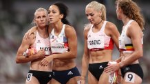 Katarina Johnson-Thompson of Team Great Britain is consoled by Verena Mayr of Team Austria as she walks off the track injured during the Women's Heptathlon 200m heats on day twelve of the Tokyo 2020 Olympic Games at Olympic Stadium on Aug.4, 2021 in Tokyo, Japan.
