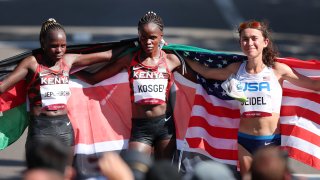 Gold medalist Peres Jepchirchir of Team Kenya, silver medalist Brigid Kosgei of Team Kenya and bronze medalist Molly Seidel of Team United States pose for photos after finishing the Women's Marathon Final on day 15 of the Tokyo 2020 Olympic Games at Kasumigaseki Country Club on Aug. 7, 2021, in Kawagoe, Japan.