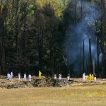 Emergency workers look over the site where the Boeing 757 of United Airlines crashed near Shanksville, Pennsylvania.