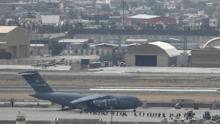 U.S. soldiers board an aircraft at the airport in Kabul on Aug. 30, 2021.