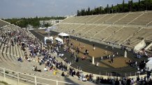 ATHENS, GREECE - NOVEMBER 3: A crowd gathers to watch athletes running in the Athens Marathon finish in the marble Panathenian stadium November 3, 2002 in Athens, Greece. The ancient Olympics were revived in 1896 in Athens, where the marathon was first run to the marble Panathenian stadium. The race, from the village of Marathon to Athens, will use an almost identical route to the original race for the 2004 Summer Games. (Photo by Milos Bicanski/Getty Images)