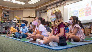 Students listen to their teacher during their first day of transitional kindergarten at Tustin Ranch Elementary School in Tustin, CA on Wednesday, August 11, 2021.