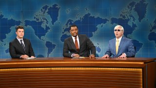 Colin Jost, Michael Che and Beck Bennett sit at anchor desk during the Weekend Update segment on Saturday Night Live.
