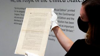 Ella Hall, a specialist in Books and Manuscripts at Sotheby's, in New York, holds a 1787 printed copy of the U.S. Constitution