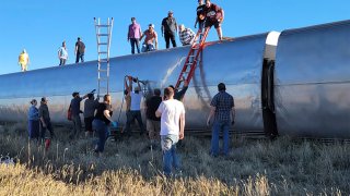 In this photo provided by Kimberly Fossen people work at the scene of an Amtrak train derailment on Saturday, Sept. 25, 2021, in north-central Montana. Multiple people were injured when the train that runs between Seattle and Chicago derailed Saturday, the train agency said.