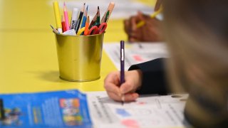 primary school students sit at their desks