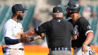 Jose Abreu #79 of the Chicago White Sox and shortstop Niko Goodrum #28 of the Detroit Tigers are kept apart by umpire Tim Timmons after Abreau was tagged out attempting to steal second base during the ninth inning at Comerica Park on September 27, 2021, in Detroit, Michigan