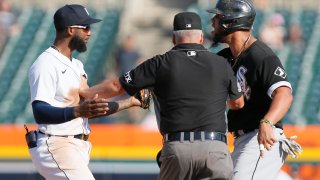 Jose Abreu #79 of the Chicago White Sox and shortstop Niko Goodrum #28 of the Detroit Tigers are kept apart by umpire Tim Timmons after Abreau was tagged out attempting to steal second base during the ninth inning at Comerica Park on September 27, 2021, in Detroit, Michigan