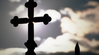 Silhouette Of Cross At Church Against Sky