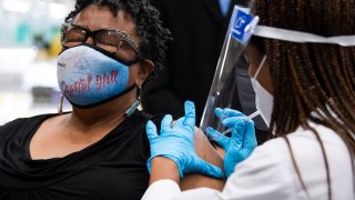 Germaine T. Leftwich, 67, receives a Pfizer covid-19 vaccine booster shot from Dr. Tiffany Taliaferro at the Safeway on Capitol Hill in Washington, D.C., on Monday, October 4, 2021.