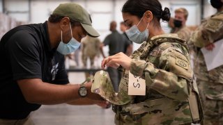 Sgt. Katiushka Rivera gets fitted for a modular scalable vest