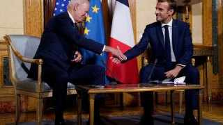 Joe Biden shakes hands with Emmanuel Macron