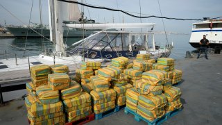 Bales of cocaine weighting some 5,2 tons and a seized yacht are displayed for the media at a Portuguese Navy base in Almada, south of Lisbon, Monday, Oct. 18, 2021. Portuguese police said Monday the seizure was the largest in Europe in recent years and the biggest in Portugal for 15 years. Police localized and intercepted the 24-meter (79-foot) yacht at sea. The operation involved police from Portugal, Spain, the Drug Enforcement Agency in the United States and the United Kingdom's National Crime Agency.