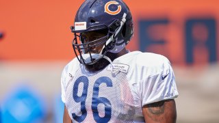 Bears tackle Akeem Hicks, pictured in his Bears helmet and a white practice jersey, waits for a play during training camp in Lake Forest.