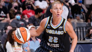 Chicago Sky guard Courtney Vandersloot drives toward the basket, with the ball in her right hand and while wearing a black uniform with blue trim and lettering