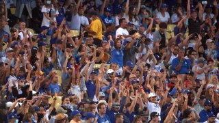 Los Angeles Dodgers fans in stands doing the wave during game vs Los Angeles Angels